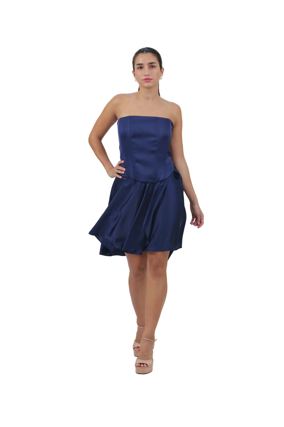 Woman wearing a strapless navy blue dress on a beige background
