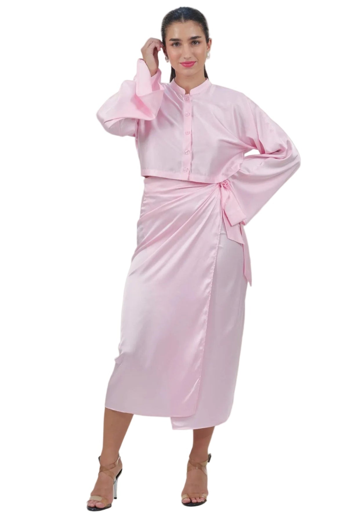 Woman wearing a pink outfit with a plain background
