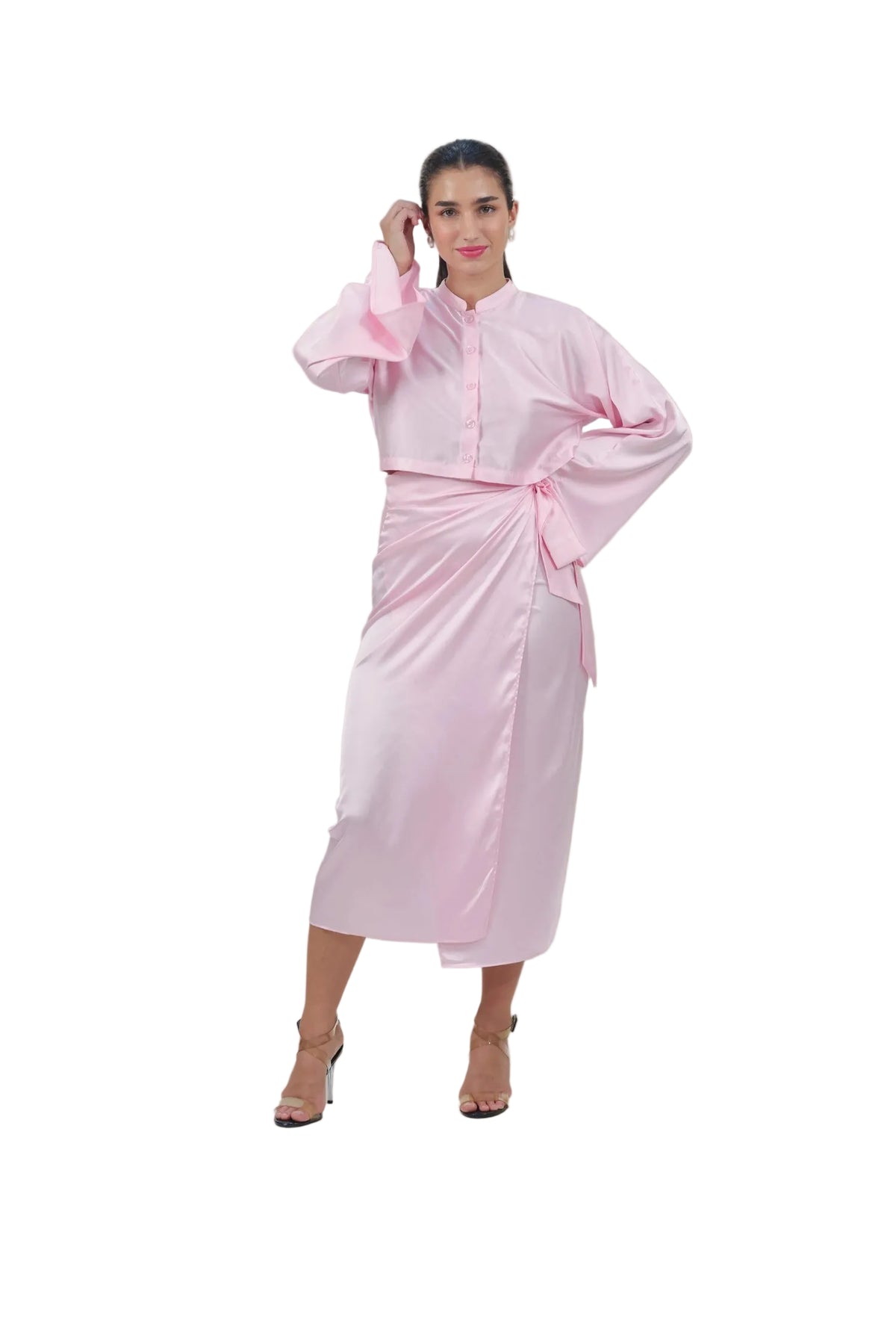 Woman wearing a pink outfit with a plain background