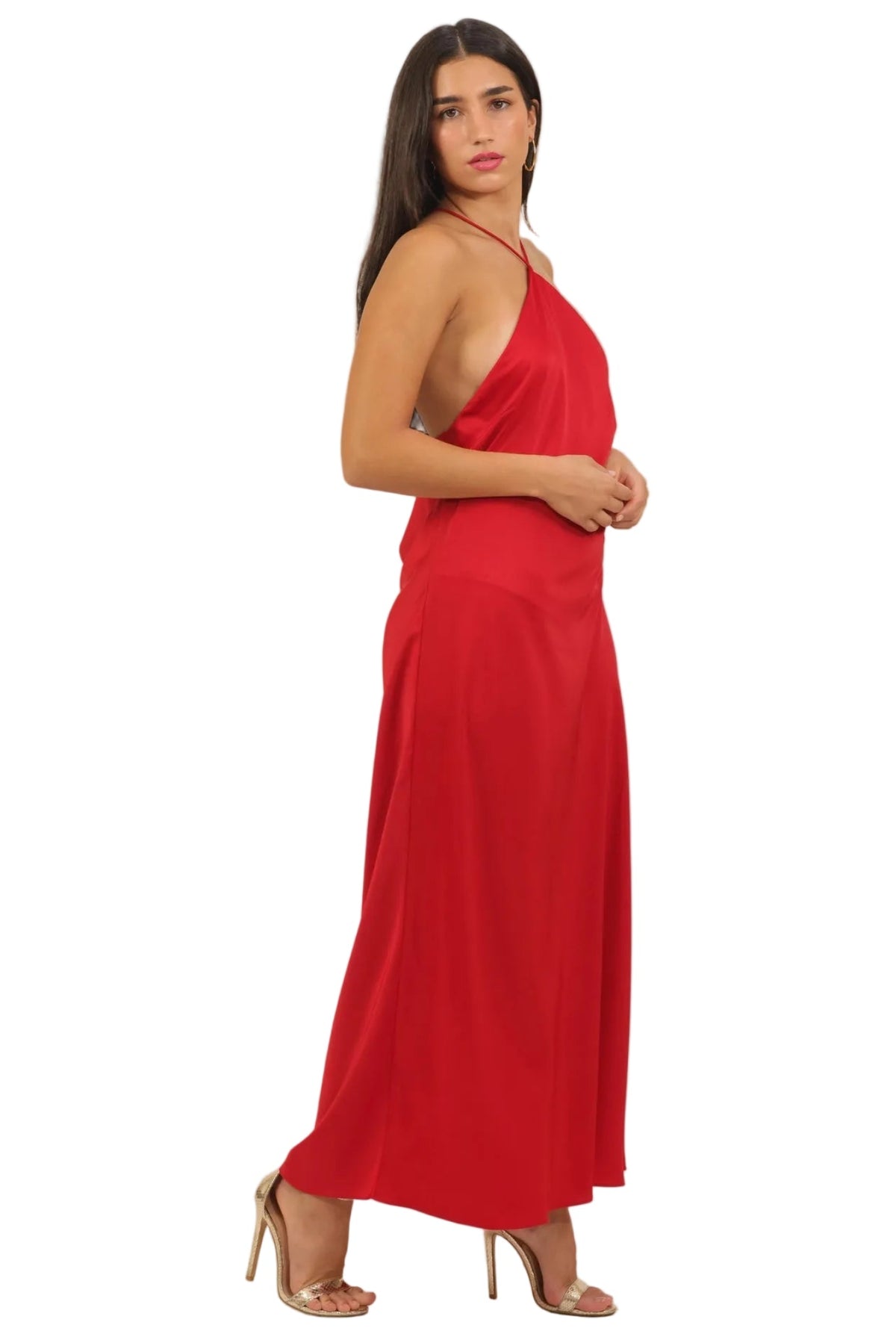 Woman wearing a red halter neck dress on a beige background