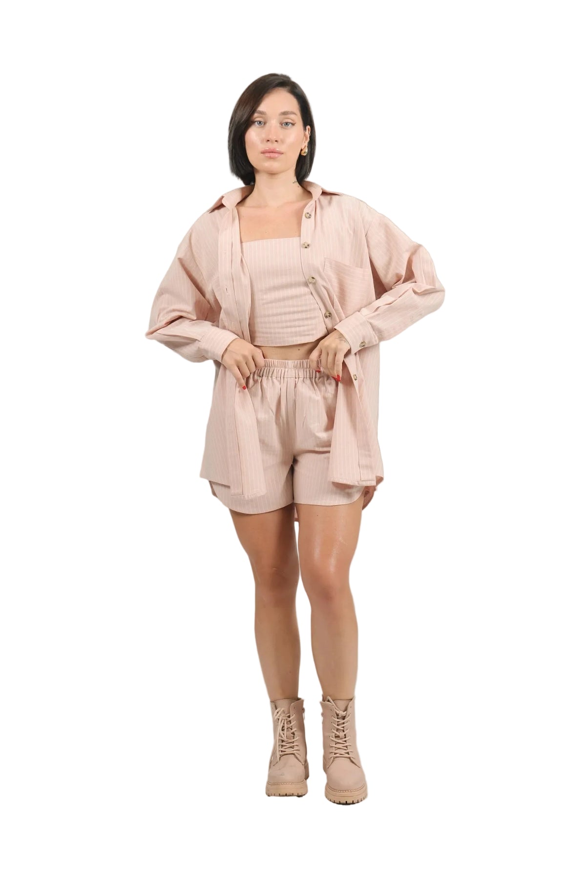 Woman wearing a pink outfit with a beige background