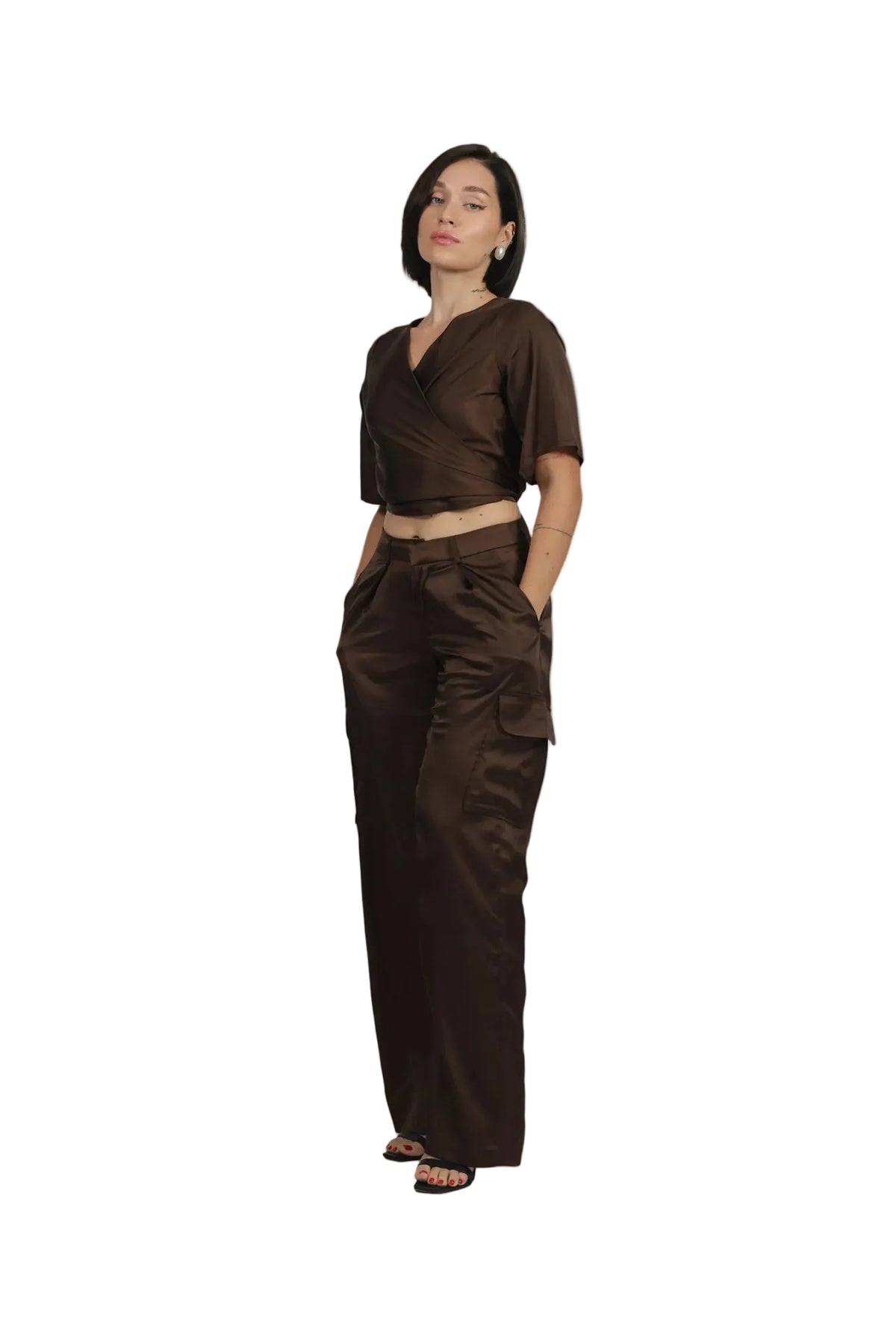 Woman wearing a brown outfit on a beige background