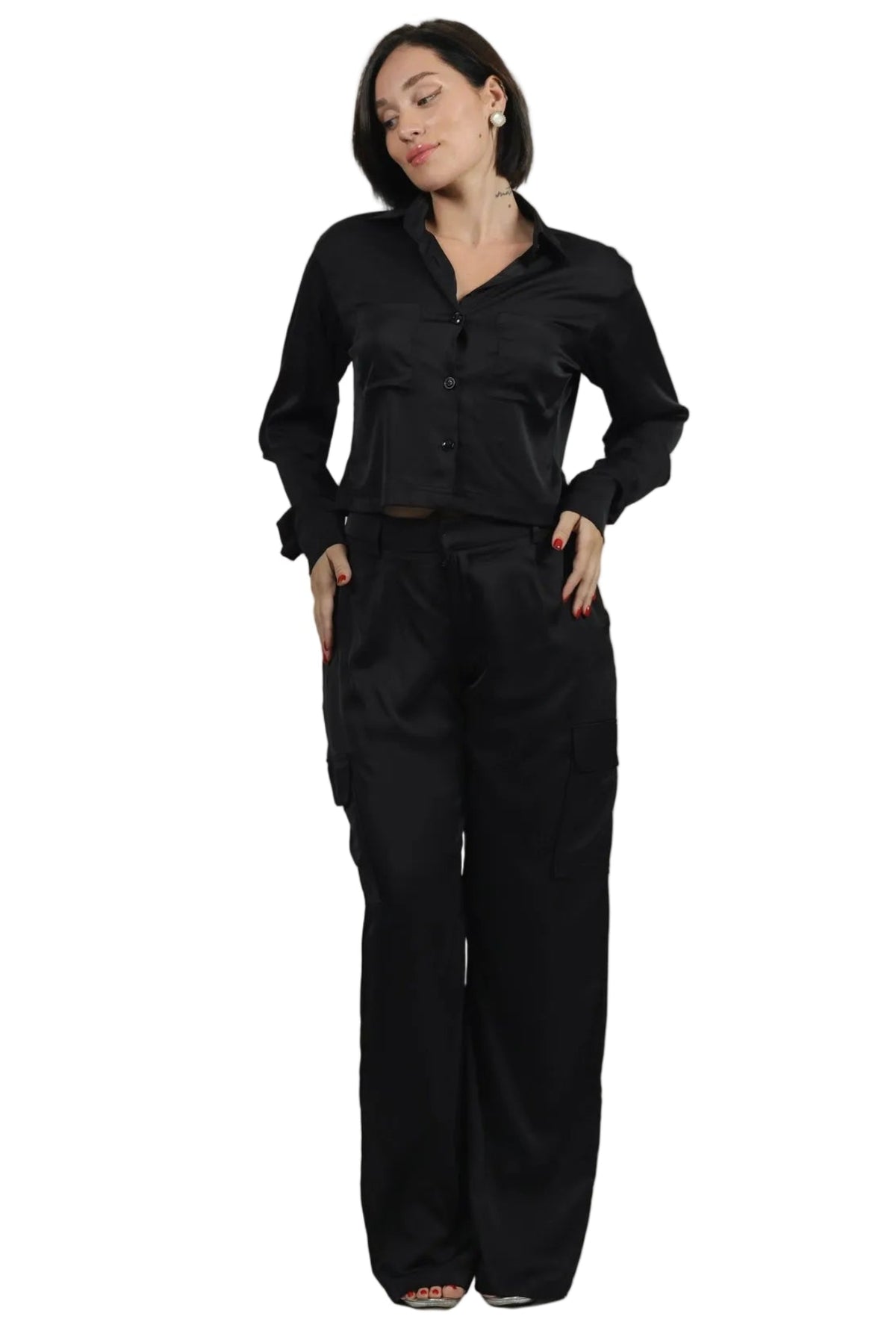 Woman wearing a black outfit on a beige background