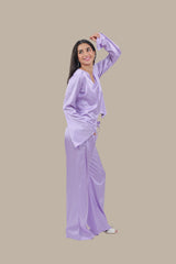 Woman wearing a light purple outfit on a beige background
