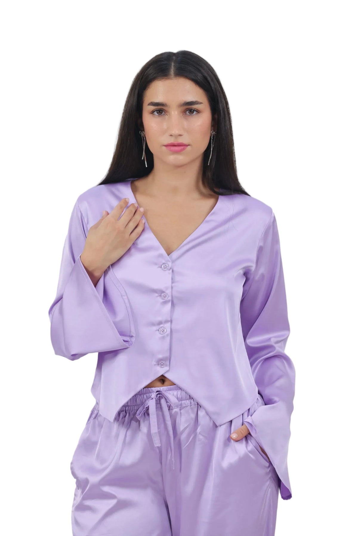 Woman wearing a light purple satin pajama set against a beige background