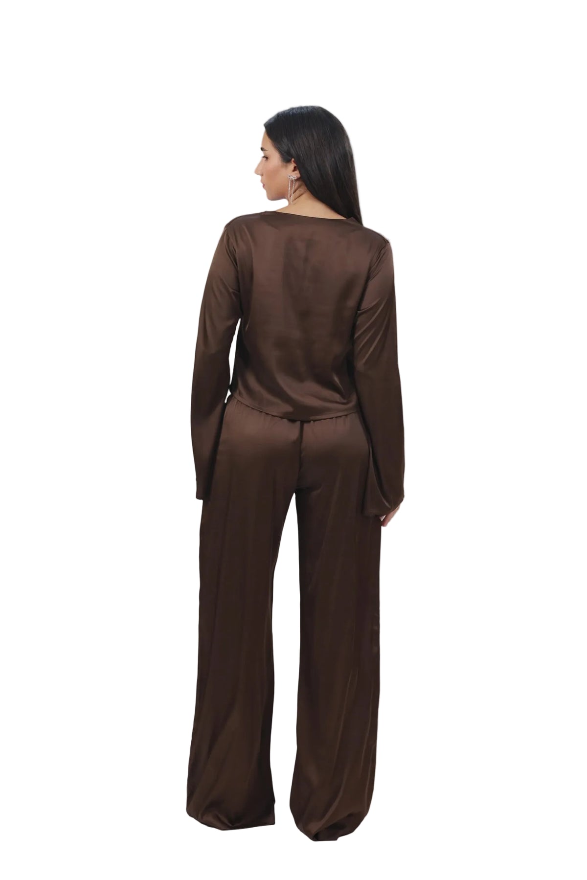 Woman wearing a brown outfit on a beige background