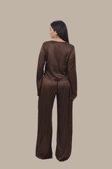 Woman wearing a brown outfit on a beige background