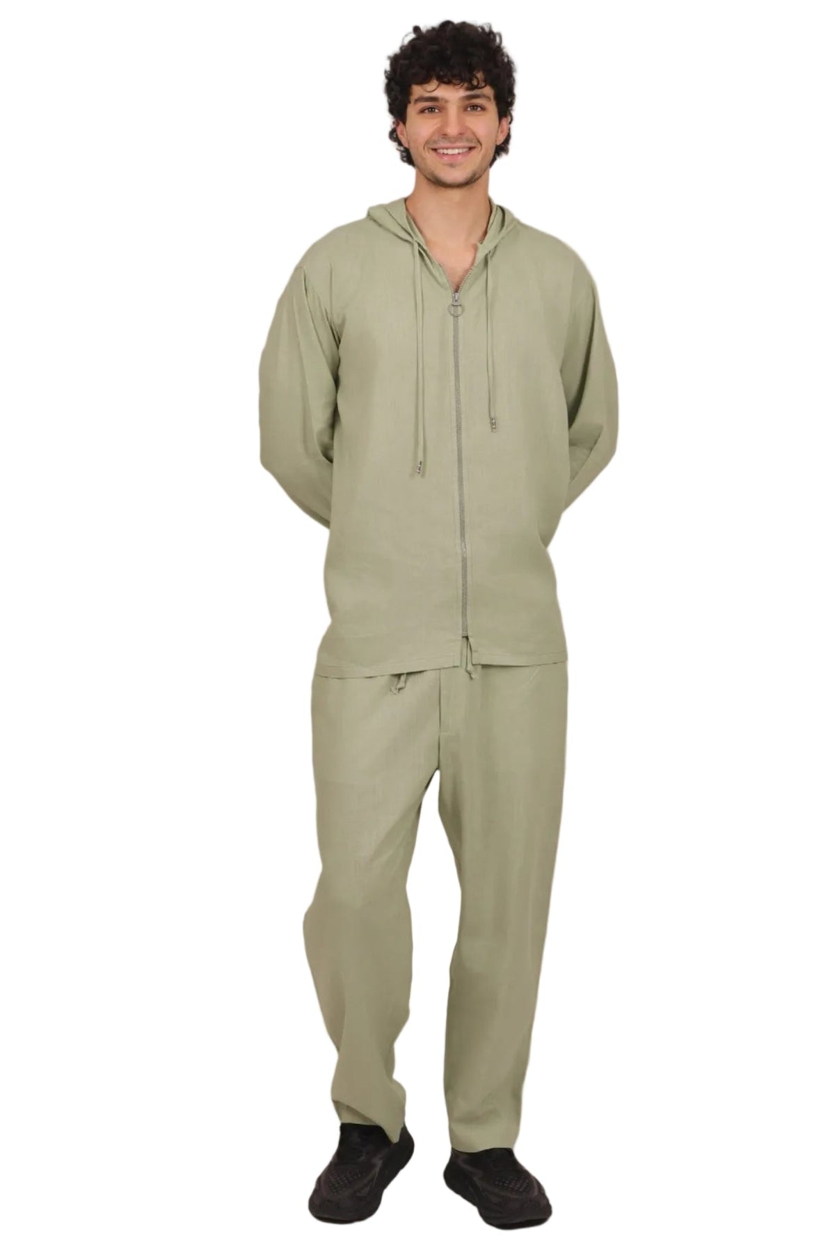 Person wearing a green tracksuit on a beige background